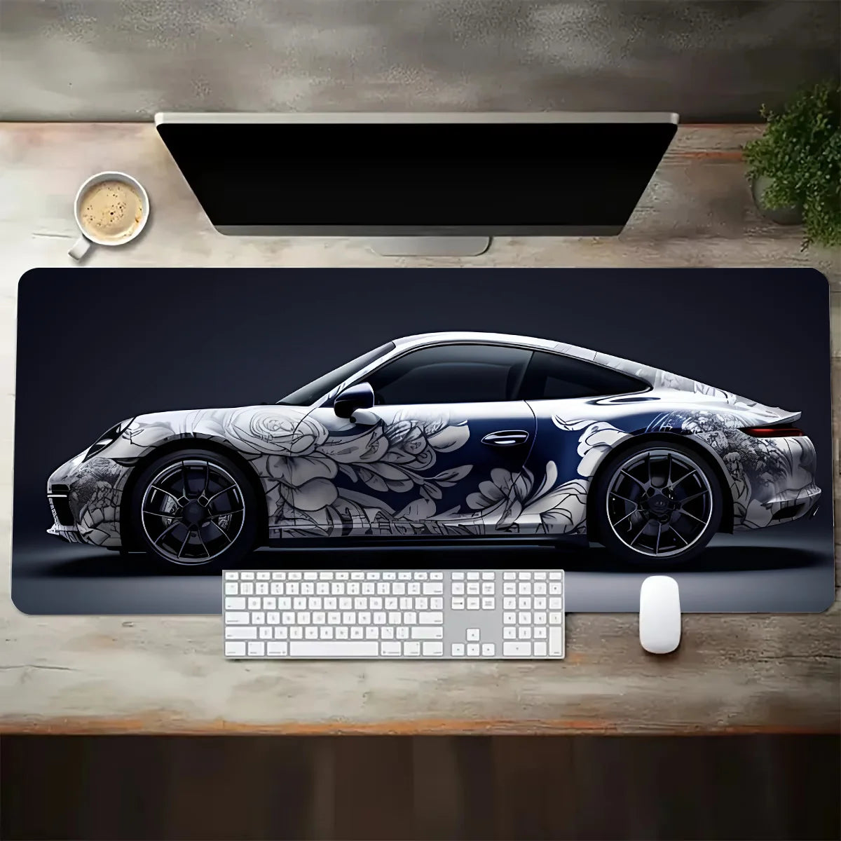 Desk setup with a car-themed mouse pad featuring a Porsche design.