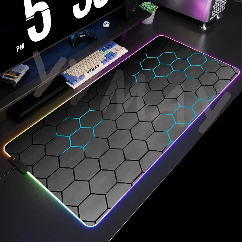 Gaming mouse pad with hexagonal pattern and RGB lighting on a desk.