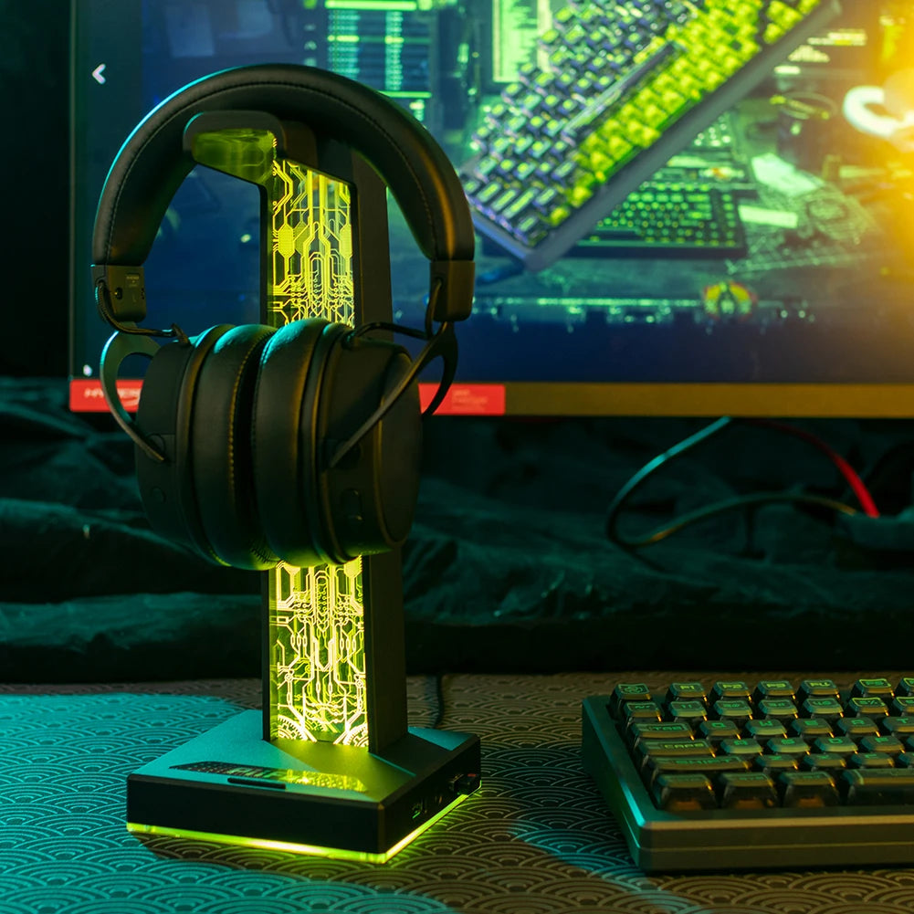Gaming headset on a stand with a computer setup in the background