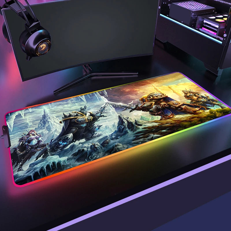 Gaming setup with a large mouse pad featuring fantasy artwork, monitor, and headphones.