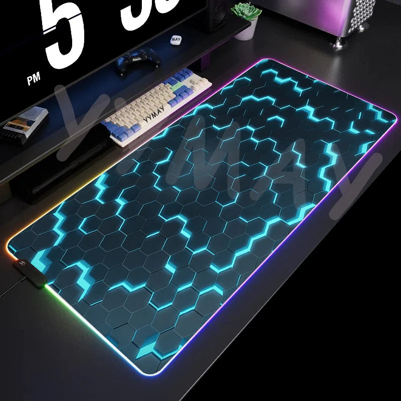 Large gaming mouse pad with hexagonal pattern and LED lighting on a desk.