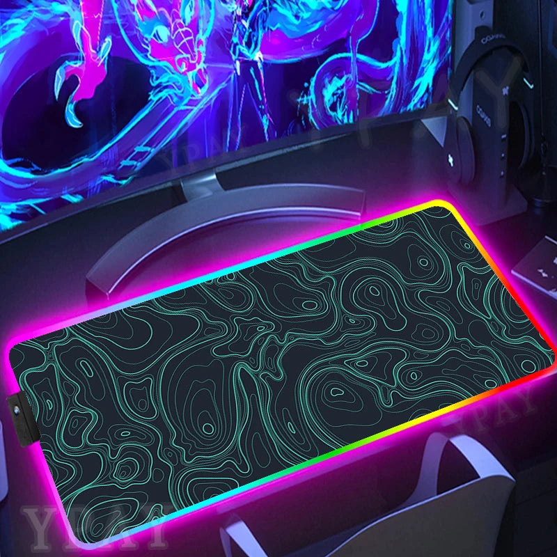 Gaming setup with a large RGB mouse pad and colorful monitor