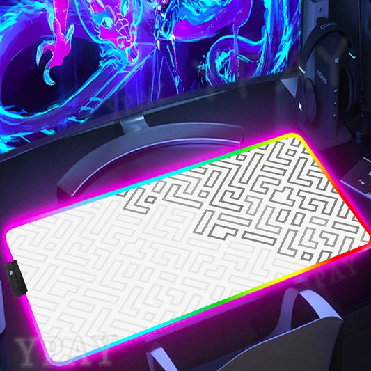 Gaming desk setup with a large mouse pad featuring a maze pattern and colorful LED lighting.
