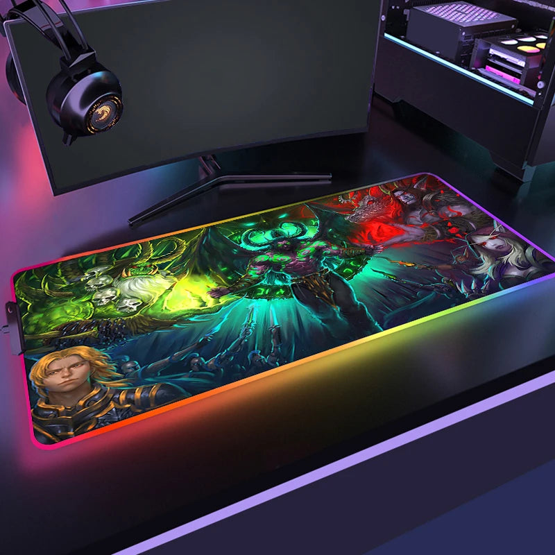 Gaming setup with a large mouse pad featuring colorful graphics and a monitor in the background.