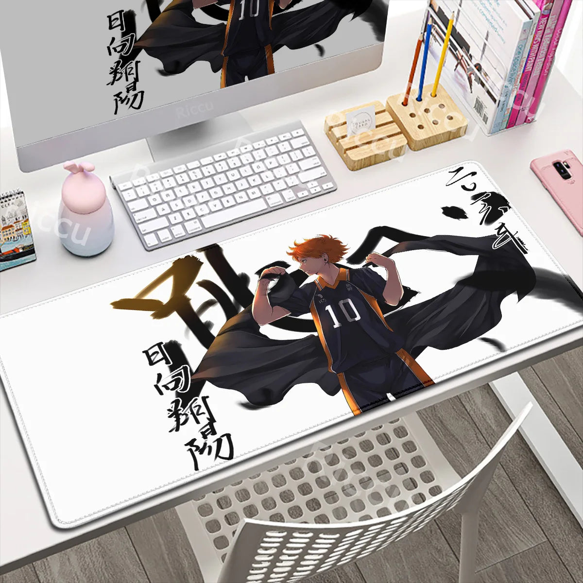 Desk setup with a large mouse pad featuring an anime character design.