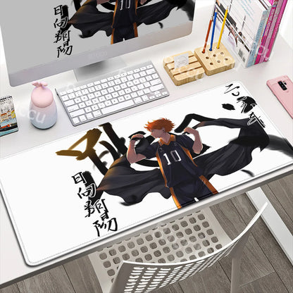 Desk setup with a large mouse pad featuring an anime character design.