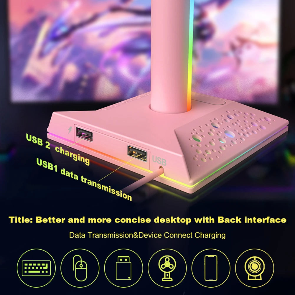 Pink computer desk with USB ports and RGB lighting in front of a blurred monitor