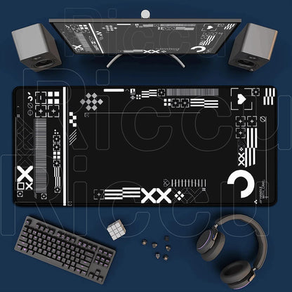 Top-down view of a desk setup with a computer monitor, keyboard, speakers, and headphones on a blue surface.