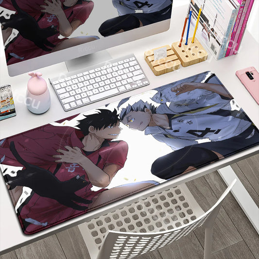 Anime-themed mouse pad on a desk with computer setup