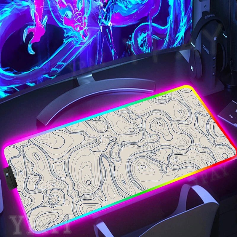 Gaming setup with a large mouse pad featuring a colorful LED border.