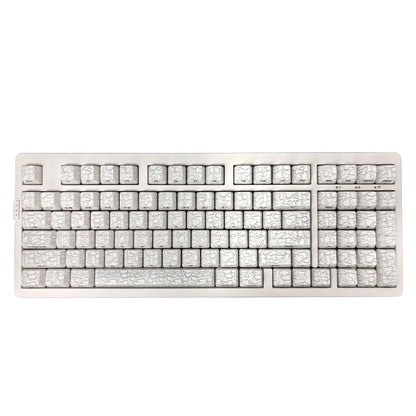 Mechanical keyboard with ice crack pattern on a white background