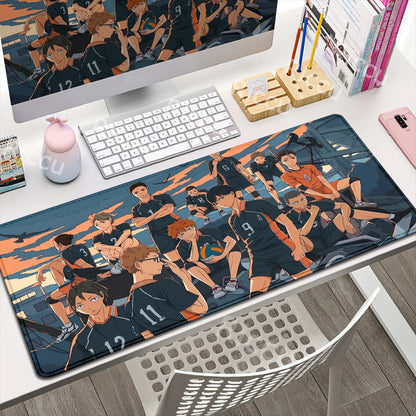 Desk setup with a computer monitor, keyboard, and mouse pad featuring anime characters.