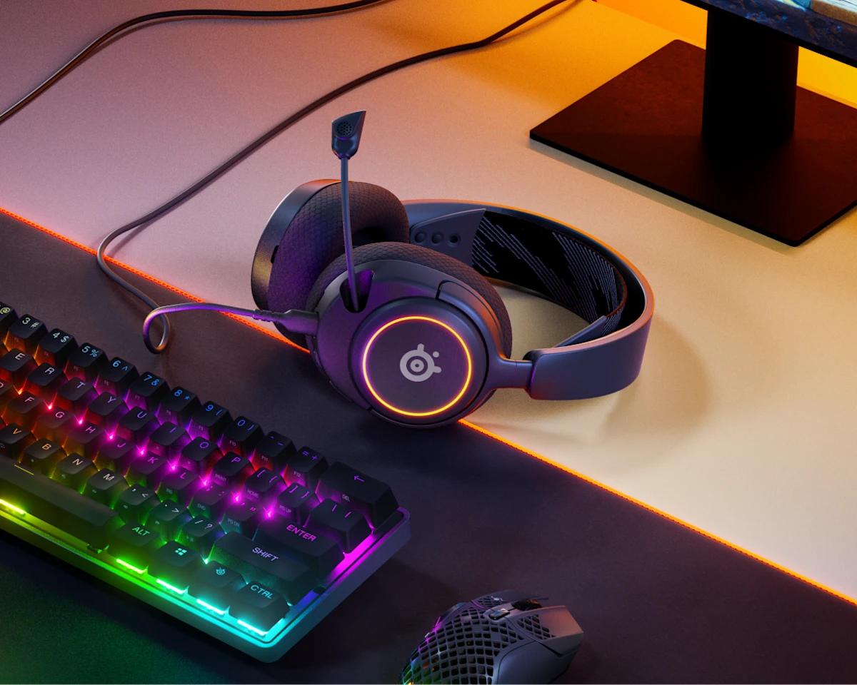 Gaming headset with RGB lighting on a desk with keyboard and mouse